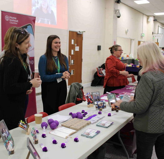 three women chatting at an event