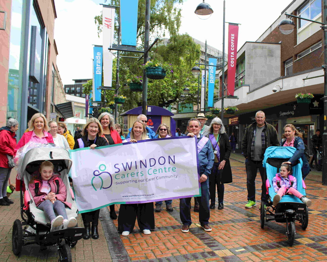 a group of people with a swindon carers centre banner