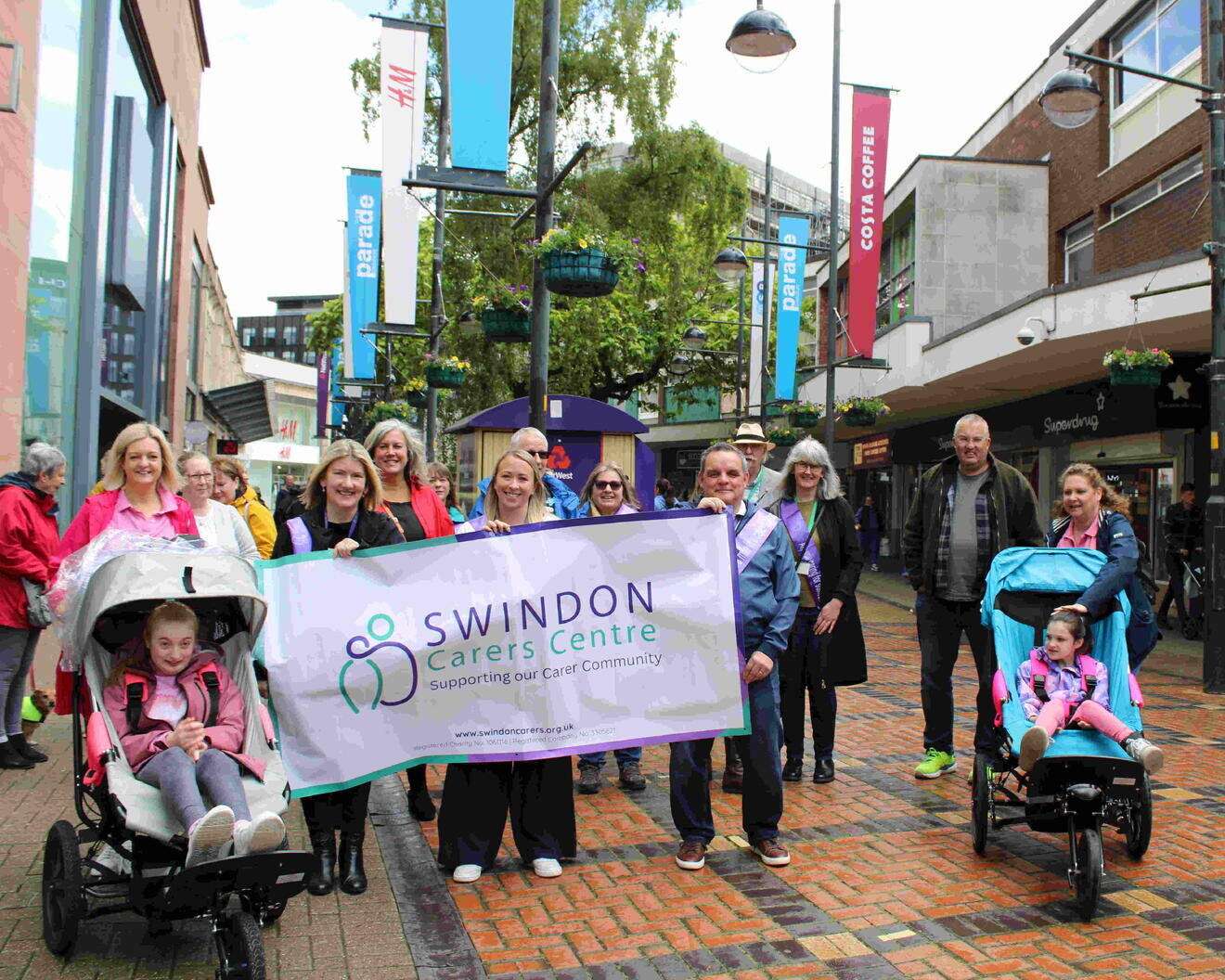 a group of people with a swindon carers centre banner