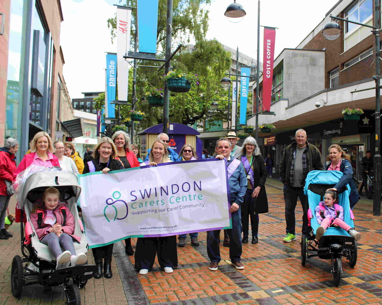 a group of people with a swindon carers centre banner