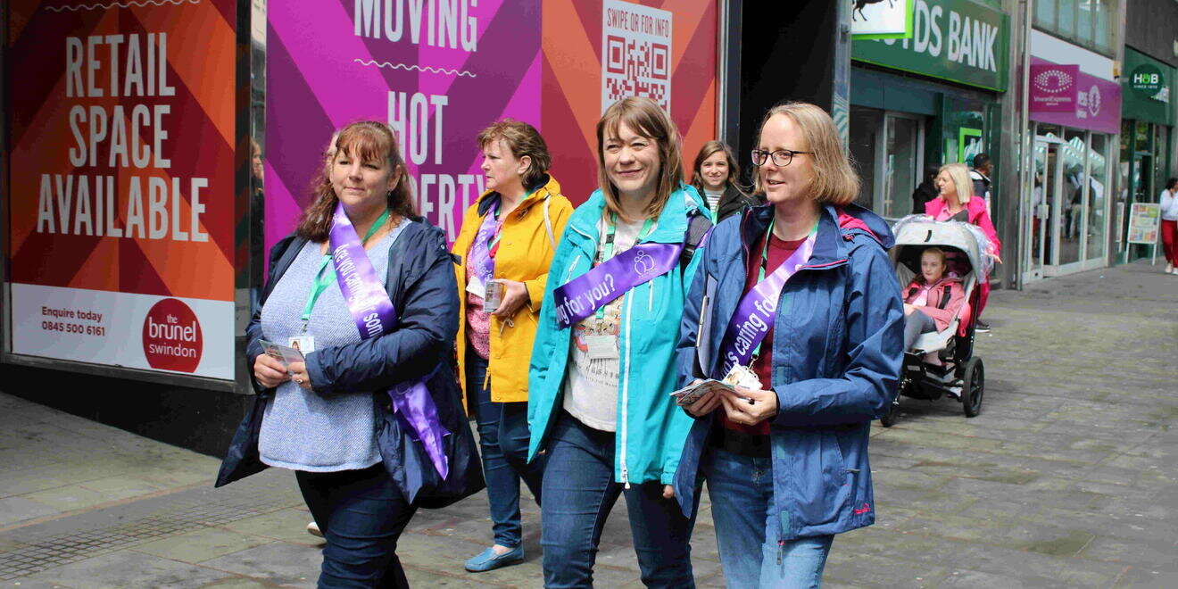 four women walking along street