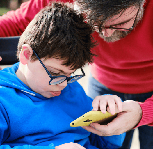 a man watching something on a phone with his son